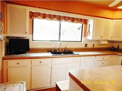 Large, bright kitchen with large window over the s