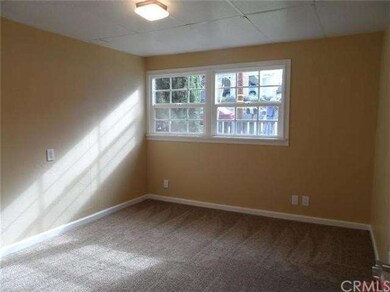A view of the second bedroom showcases new carpeti