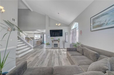 Living area featuring a chandelier, high vaulted c