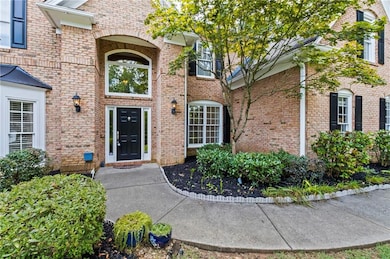 Doorway to property featuring brick siding