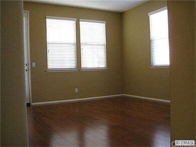 Lots of windows  and beautiful wood flooring in li