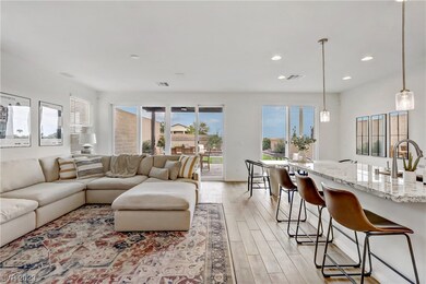 Wood tile floors open living room to kitchen and d