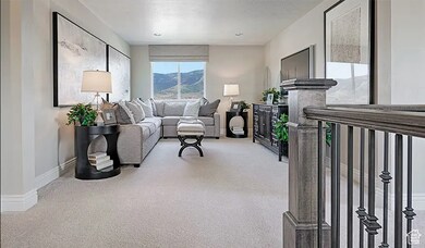 Living area with light carpet and baseboards