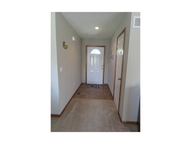 Bright, tiled entry with coat closet