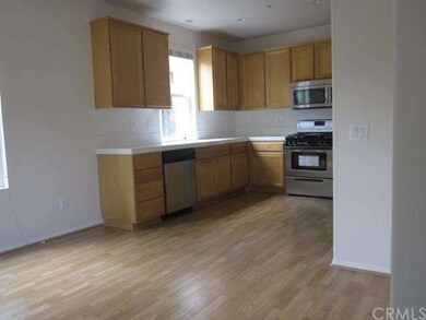 Spacious kitchen with laminate flooring, new paint