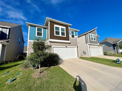 View of front of house featuring a garage, driveway, and a front lawn