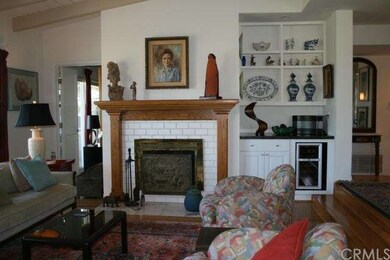 Fireplace and built-in dry bar with wine fridge in