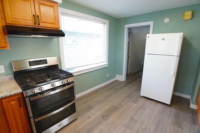 Kitchen with white refrigerator, stainless steel g