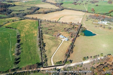 Aerial overview of property's location featuring rural landscape and property parcel outlined