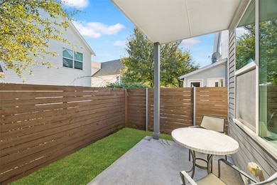 Fenced backyard with a patio