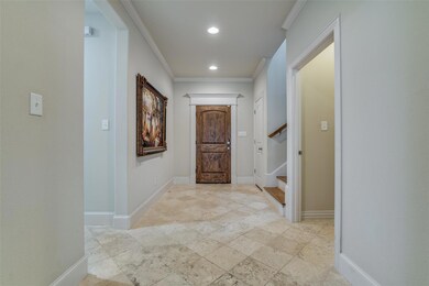 Foyer is welcoming, light and open, featuring crown molding