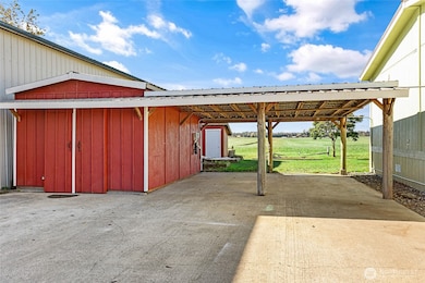 Small shop with electric, double carport & EV charging station