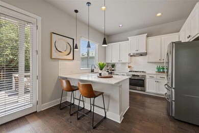 Kitchen featuring white cabinets, under cabinet r