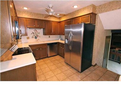 Steps from the family room lead into the kitchen w