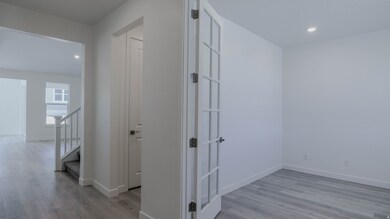 Hallway featuring recessed lighting, light wood finished floors, and stairs