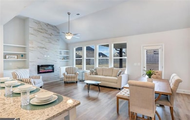 Living room with visible vents, ceiling fan, wood 