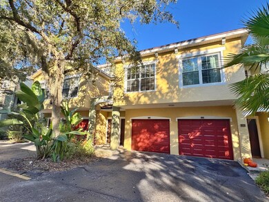 View of front facade featuring stucco siding, driveway, and an attached garage