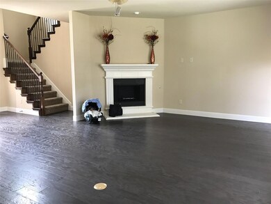 Unfurnished living room with dark hardwood / wood-style floors