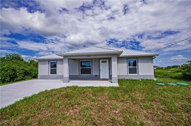 View of front of house featuring metal roof, a por