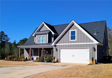 View of front of property with driveway, a porch, 
