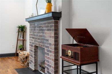Interior details with a fireplace and wood finished floors