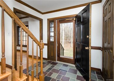 The foyer has a solid wood door and storm, coat cl