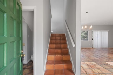 Entry with half bath to the left, staircase straig