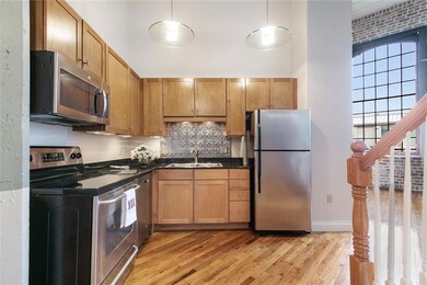 The kitchen has stainless appliances, granite coun