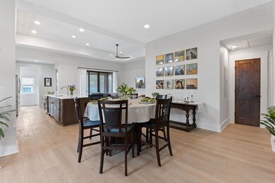 Dining room featuring recessed lighting, a raised