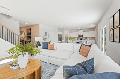 Living room with recessed lighting and stairs