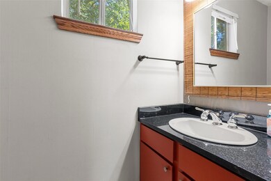 Half bathroom downstairs with granite countertops 