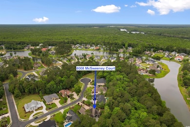 Birds eye view of property featuring a water view, a residential view, and a wooded view