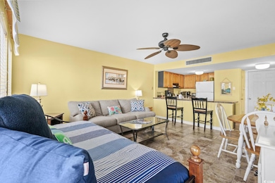 Living room with visible vents, baseboards, and a 