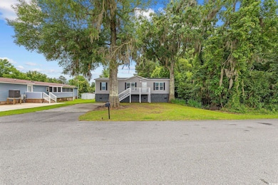 View of front of home featuring stairs and a front yard