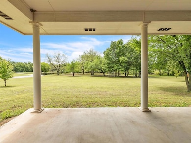 View of patio / terrace featuring view of wooded a