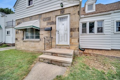 View of exterior entry featuring a lawn