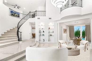 Sitting room facing the stairs and vaulted 22' high ceilings