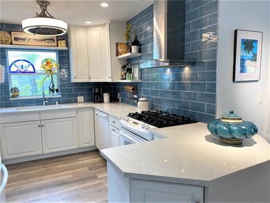 kitchen has decorative glass backsplash