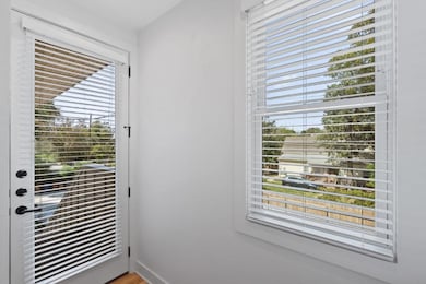 Doorway with baseboards and wood finished floors