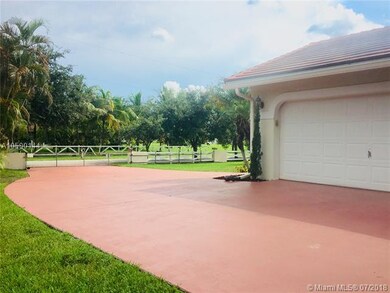 The attached two car garage sits on the side of th