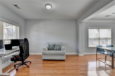 Home office featuring light wood-type flooring and baseboards