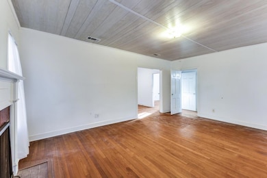 Unfurnished living room featuring visible vents, 