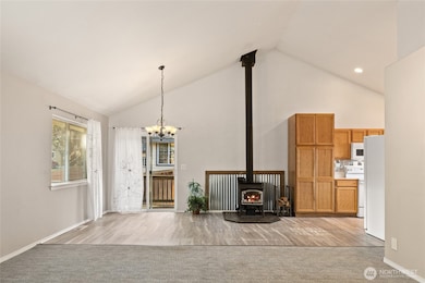 Slider leads to the side and back yard. Nice wood stove to keep you warm all winter! Large pantry cupboard for all your canned goods!