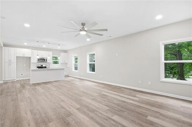 Unfurnished living room featuring recessed lighting, ceiling fan, healthy amount of natural light, and light wood-style flooring