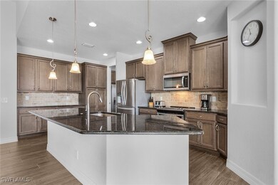 Kitchen with stainless steel appliances, wood fini