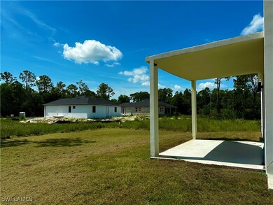 View of grassy yard with a patio