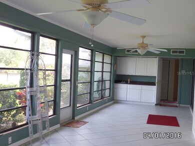 ANOTHER VIEW OF FLORIDA ROOM OVERLOOKING LAKE.  NO