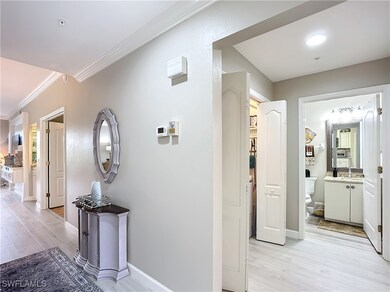 Corridor featuring ornamental molding, sink, and l