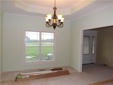 Formal dining room with hardwood & tray ceiling.