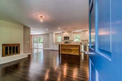 As soon as you walk in the front door you are greeted by this fabulous open layout, gorgeous refinished hardwoods and custom kitchen!